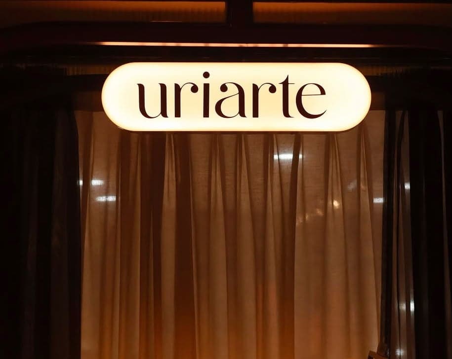Letrero luminoso de Uriarte frente a una cortina